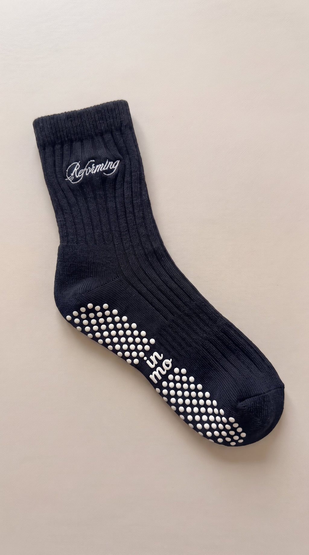 Black wide-rib Reforming sock with script embroidery and white sole grips