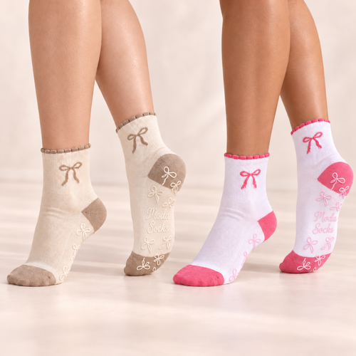Pink and beige bow grip socks worn to show the bow details and soles
