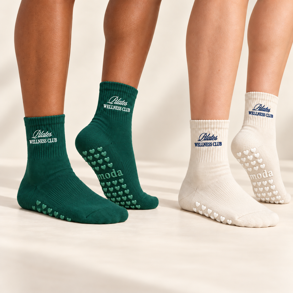 Forest green and almond beige Pilates Wellness Club socks worn to show heart-shaped grips